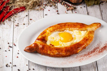 Traditional Georgian and Armenian cuisine. Khachapuri with suluguni cheese and egg yolk. background image. Copy space, selective focus