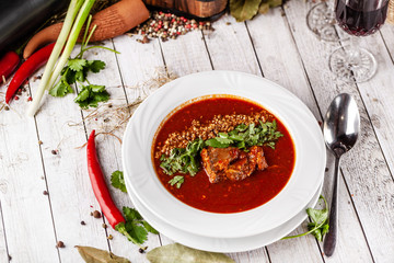 Traditional Georgian and Armenian cuisine. Tomato soup with rice Harcho of lamb, with walnut, garlic and cilantro. Copy space, selective focus