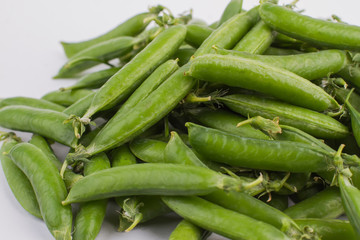 Fresh green peas, close up. White isolated background.