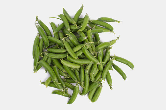 Pile of raw green organic snap peas. White isolated background.