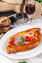 Traditional Georgian and Armenian cuisine. Khachapuri with suluguni cheese and egg yolk. background image. Copy space, selective focus