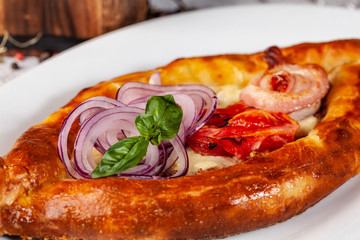 Traditional Georgian and Armenian cuisine. Khachapuri with suluguni cheese and egg yolk. background image. Copy space, selective focus