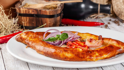 Traditional Georgian and Armenian cuisine. Khachapuri with suluguni cheese and egg yolk. background image. Copy space, selective focus
