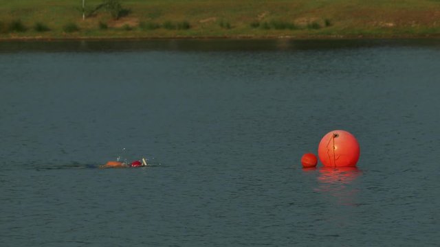 A swimmer reachs his targer