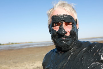 Senior man in healing mud