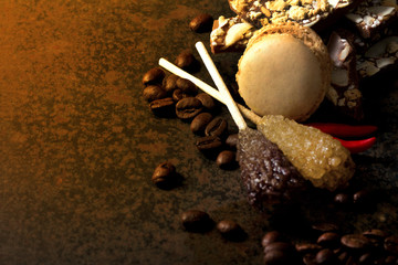 Coffee on dark background with macaroons and sugar crystals