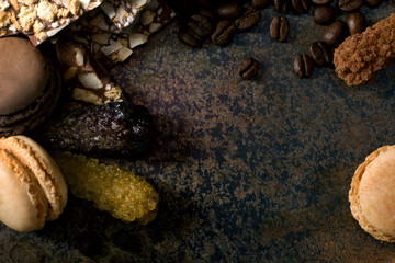 Coffee on dark background with macaroons and sugar crystals