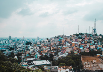 Cityscape view of Guayaquil in the Guayas region, Ecuador's largest city. Wealth disparity between the financial district and colorful barrio of Cerro del Carmen seen from Las Penas on Santa Ana hill