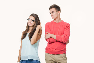 Studio shot of disgruntled couple wearing casual clothes standing back to back frowning their faces. Discord in the relationship. Divergence of points of view