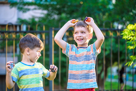 Two Boys Playing With A Beyblade, Spinning Top Kid Toy. Popular Children Game Tournament.