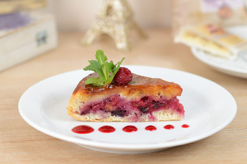 cake with raspberries on a white plate