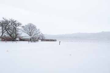 Harbour pier jetty underwater flooding extreme wet rainstorm winter weather Scotland UK Balmaha Loch Lomond