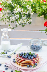 Vintage pancakes outside garden with blueberries