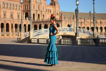 Obraz premium The beautiful Spanish girl with green flamenco dress