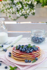 Vintage pancakes outside garden with blueberries