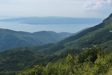 Panoramic view of the adriatic sea and mountains in Croatia, Dalmatia. In the valley lies the town Senj. South Europe. Aerial view down from Velebit national park.