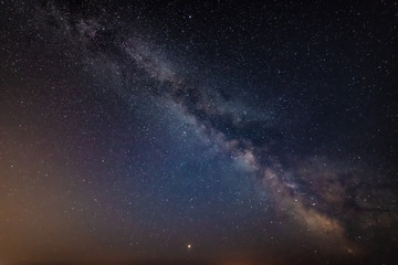 Beautiful vibrant image of Milky Way galaxy over sea landscape in Dorset England