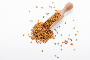 fragrant grains of fenugreek on a white background