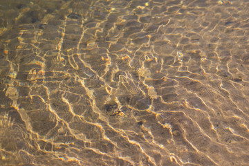 yellow reflections of the sun in the river water