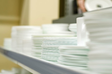 Many plates on the shelf of the store white set cooking