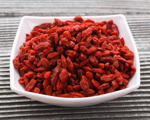 dried goji berries on a wooden rustic background