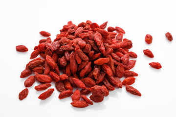 dried goji berries on a white acrylic background