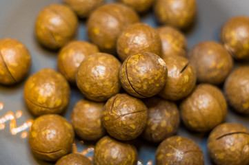 Fototapeta premium macadamia, Australian nut in a ceramic plate