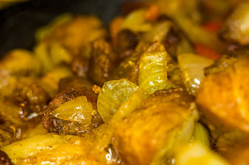 Roast meat, onions, carrots and spices, boiling in oil