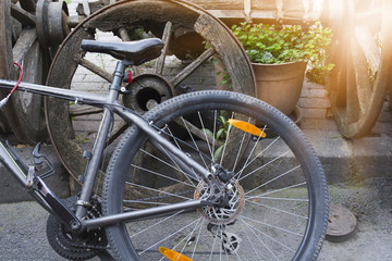 Fototapeta na wymiar bike wheel is leaning against the old wheel