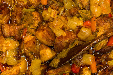 Roast meat, onions, carrots and spices, boiling in oil