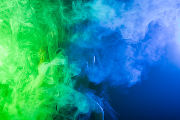 Young woman in neon light and smoke of e-cigarettes or vape