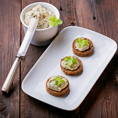 Canape with fish pate on a white plate