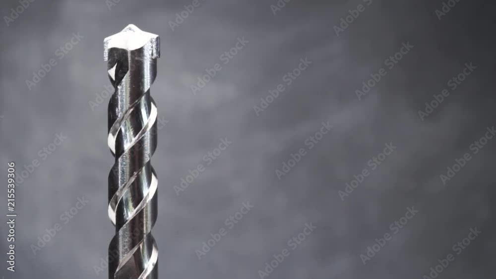 Aufkleber Silver drill bit rotation on a dark background. Macro view.