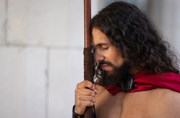 The Roman warrior leaned against the spear.