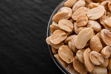 fresh peanuts on a dark stone background