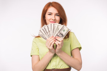 Redhead woman with money on white background