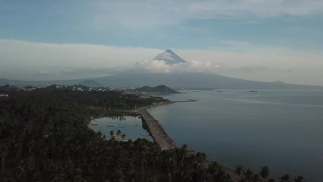 AERIAL SHOT: Puro and Lamba, Legazpi City, Philippines. Views of cocount trees, Mayon Volcano and the sea