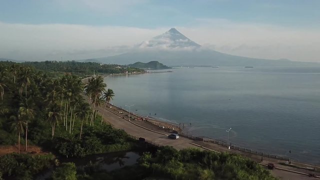 AERIAL SHOT: Puro and Lamba, Legazpi City, Philippines. Views of cocount trees, Mayon Volcano and the sea