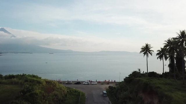 AERIAL SHOT: Puro and Lamba, Legazpi City, Philippines. Views of cocount trees, Mayon Volcano and the sea