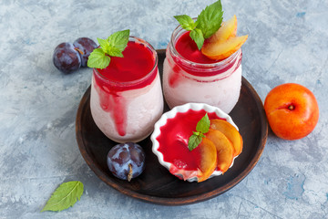 Artisanal plum ice cream with fruit sauce and mint.