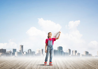 Concept of careless happy childhood with girl dreaming about future