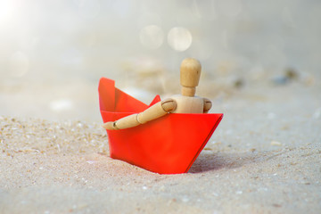 wooden models feel lonely on the beach.