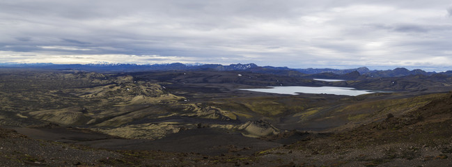 Colorful wide panorama, panoramic view on Volcanic landscape in Lakagigar, Laki Volcano crater chain with green lichens, moss and lakes Kambavatn and Lambavatn, Iceland, moody sky background