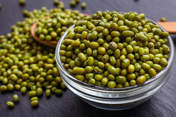 fresh Mung beans on a dark stone background