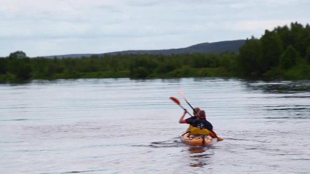 Following and Passing Two Men Tandem Kayak in Sweden