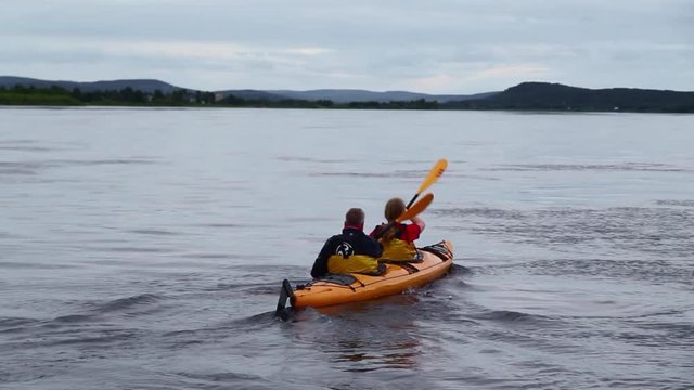 Following Two Men Tandem Kayak in Lake in Sweden