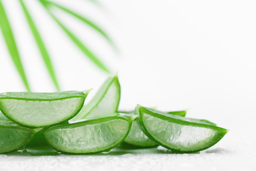 Aloe vera leaf slices with gel on white background.