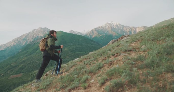 Young mountaineer hiking up a mountain. Adventurer climbing up. Adventures, zen concept 4k