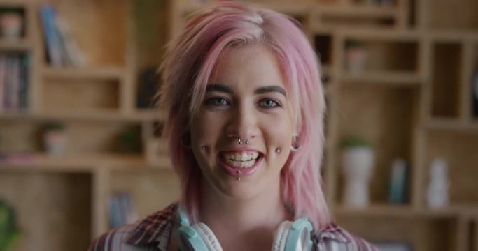 portrait of young punk woman laughing cheerful wearing pink funky hairstyle face piercings beautiful successful caucasian woman alternative fashion style individuality