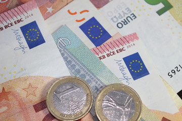 Mix of euro banknotes and coins altogether